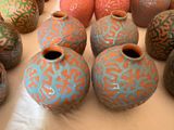 many vases that are sitting on a table