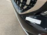 a close up of a car ' s grille with a sticker on it
