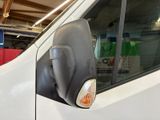 a white van parked in a garage with its door open