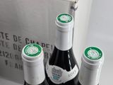 three bottles of wine sitting on a table next to a box