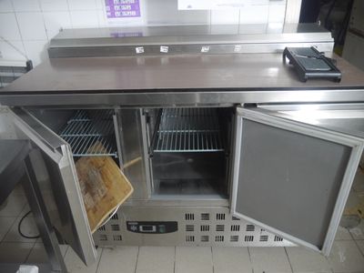 a small refrigerator with a door open in a kitchen