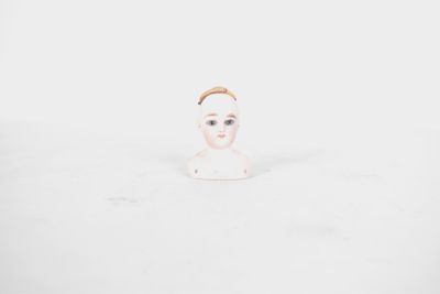 baby doll in the snow with a crown on her head
