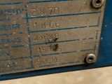 a close up of a metal plate on a blue machine