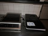 two stoves that are sitting on a counter top