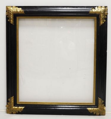a black and gold picture frame hanging on a wall