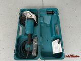 a blue tool in a blue case on the floor