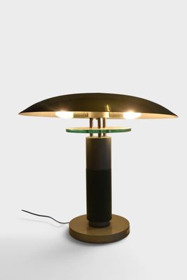 an image of a table lamp with a black base and a gold shade