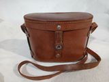 brown leather camera case with strap on a white background