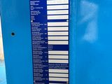 a close up of a blue machine with a sign on it