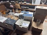 bottles of wine and glasses on a table in a wine shop
