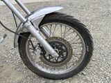 a close up of a motorcycle tire on a gravel road