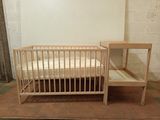 un lit de bébé et un lit dans une petite chambre