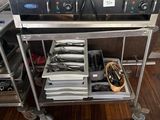 stainless steel kitchen cart with two pans on top of it in a kitchen