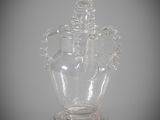 a glass vase with a lid on a table