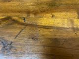 a close up of a wooden table with a knife on it