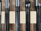 five different types of drill bits in a wooden box