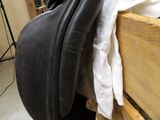a horse saddle that is sitting on top of a wooden box