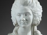 a white statue of a woman with long hair