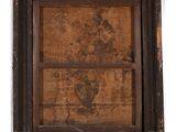 an old picture of a wooden frame with a picture of a man