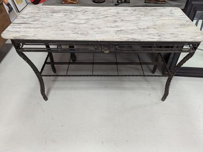 a table with a marble top in a store