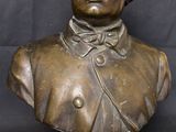 bronze bust of a woman with curly hair on a marble base