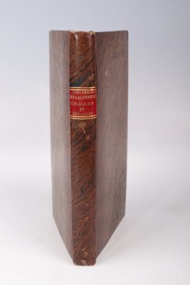 a brown book with a red label on it