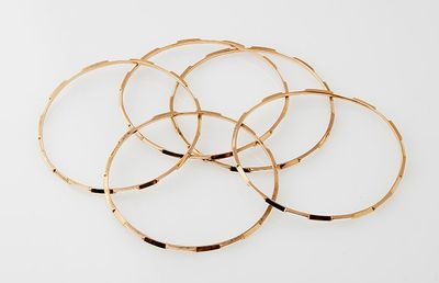 gold plated bang bracelets on a white background