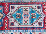 an image of a red and blue rug with a pattern on it