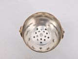 an overhead view of a silver bowl with stars on it