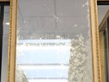 a mirror sitting on top of a table in a room