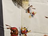 a person that is holding a scarf with a picture of birds on it