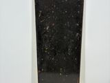an old black suitcase sitting on a white surface
