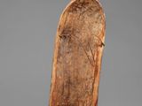 a close up of a wooden object on a gray surface