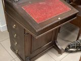a small desk with a red book on it