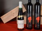 three bottles of wine sitting on a table next to a wooden box