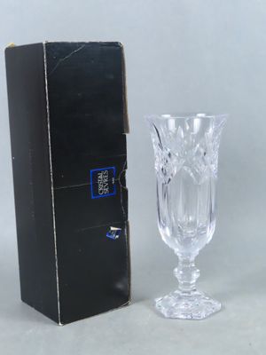 a wine glass sitting next to a box on a table