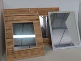 two mirrors sitting on a shelf next to each other