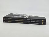three books are stacked on top of each other on a white surface