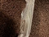a plastic bag that is on the ground next to a cell phone