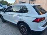 the rear end of a white volkswagen suv parked in a parking lot