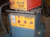 two welding machines sitting on top of each other in a garage