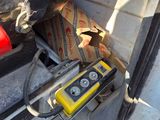 a yellow and black device sitting in the back of a truck