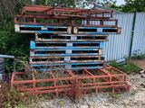 a pile of pallets sitting next to a trash can