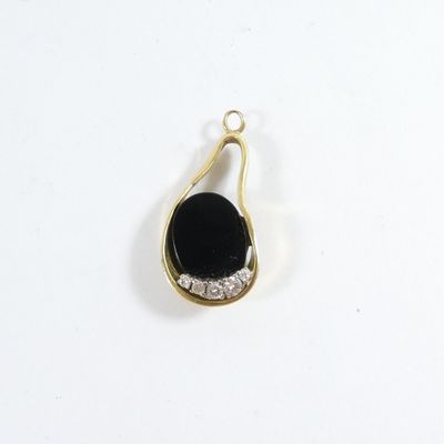 a close up of a black and white pendant on a white surface