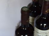 three bottles of wine sitting on top of a table next to each other