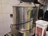 a large pot sitting on top of a table in a kitchen