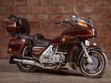 a brown motorcycle parked in front of a brick wall