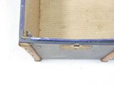 a small blue suitcase with a metal handle on a white surface