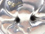 a silver cake pan with a heart shaped design on it
