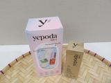 a box of yepoda next to a bottle of liquid